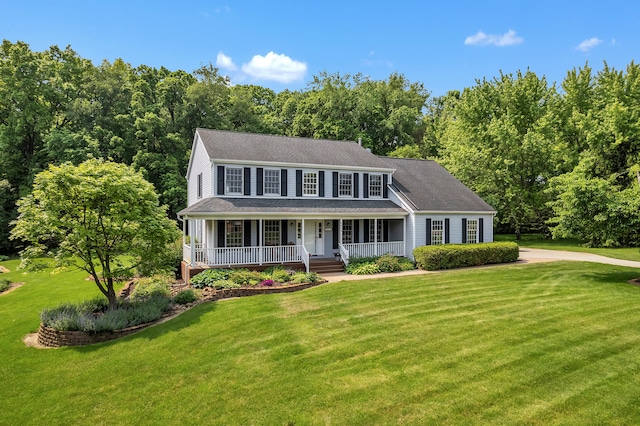 6676 Ralaric Dr, Dexter, MI 48130 - colonial-style house with covered porch and a front lawn