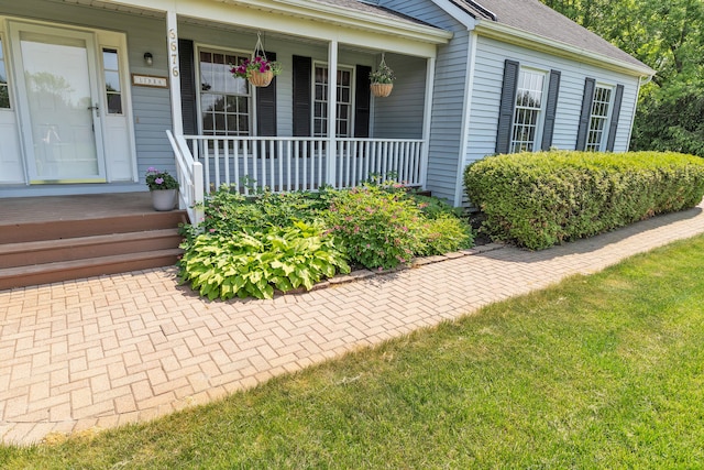 6676 Ralaric Dr, Dexter, MI 48130 - entrance to property with a porch and roof with shingles