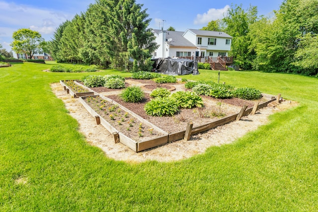 6676 Ralaric Dr, Dexter, MI 48130 - view of green lawn featuring a garden and a deck