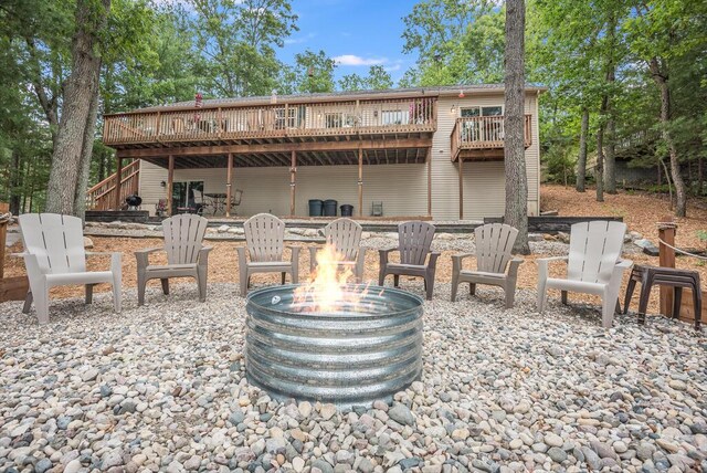8833 W Velt Ave, Baldwin, MI 49304 - view of patio / terrace with an outdoor fire pit, a wooden deck, and stairway