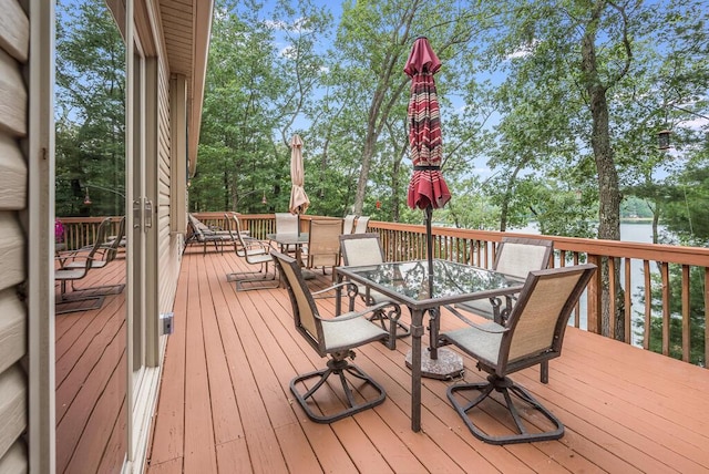 8833 W Velt Ave, Baldwin, MI 49304 - deck with outdoor dining area and view of wooded area