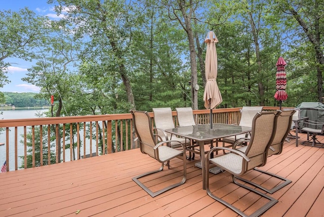 8833 W Velt Ave, Baldwin, MI 49304 - wooden terrace featuring outdoor dining space, a water view, and view of wooded area