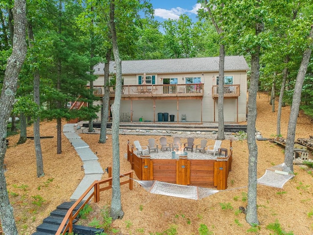 8833 W Velt Ave, Baldwin, MI 49304 - rear view of property with a wooden deck, a hot tub, and a shingled roof