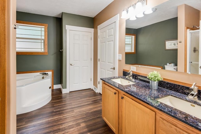 8833 W Velt Ave, Baldwin, MI 49304 - full bathroom with a bath, a stall shower, double vanity, wood finished floors, and baseboards