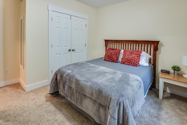 8833 W Velt Ave, Baldwin, MI 49304 - bedroom featuring carpet flooring, baseboards, and a closet