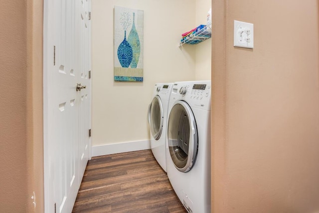 8833 W Velt Ave, Baldwin, MI 49304 - laundry room with dark wood-style flooring, washing machine and clothes dryer, and baseboards