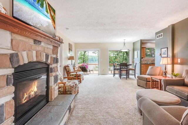 8833 W Velt Ave, Baldwin, MI 49304 - living room featuring a fireplace, carpet, and a textured ceiling