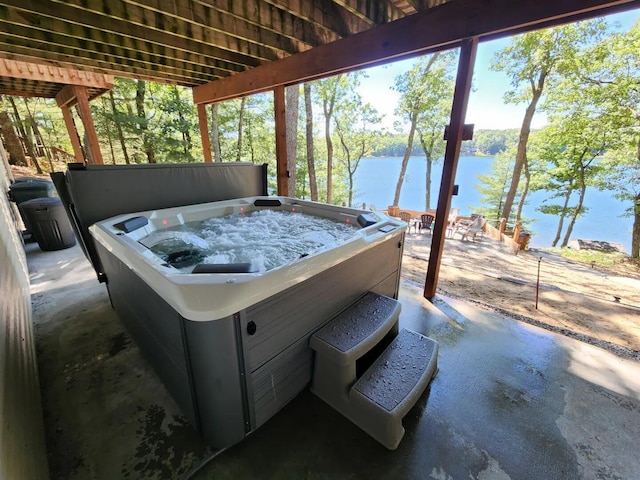 8833 W Velt Ave, Baldwin, MI 49304 - view of patio / terrace with a hot tub and a water view