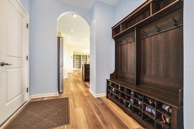 1162 Cooks Corner Ct SE, Byron Center, MI 49315 - mudroom with arched walkways, wood finished floors, and baseboards