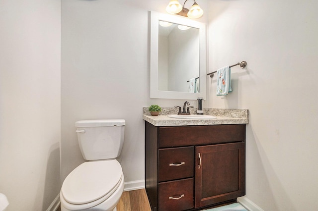 1162 Cooks Corner Ct SE, Byron Center, MI 49315 - bathroom featuring vanity, baseboards, toilet, and wood finished floors
