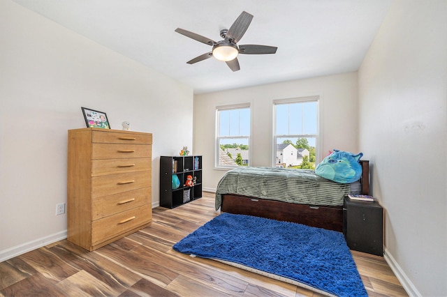1162 Cooks Corner Ct SE, Byron Center, MI 49315 - bedroom with baseboards, wood finished floors, and ceiling fan