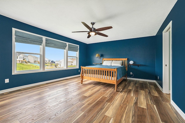 1162 Cooks Corner Ct SE, Byron Center, MI 49315 - bedroom featuring wood finished floors, baseboards, and a ceiling fan