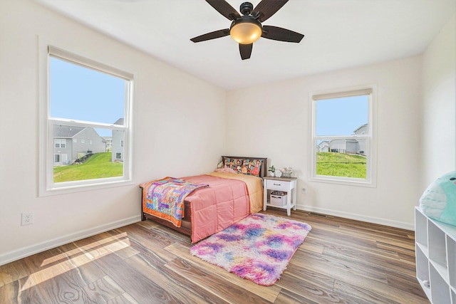 1162 Cooks Corner Ct SE, Byron Center, MI 49315 - bedroom featuring wood finished floors, baseboards, and a ceiling fan