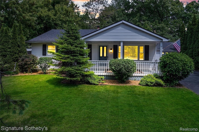 300 Cornell St, Howell, MI 48843 - view of front of property with a porch, a lawn, and a shingled roof