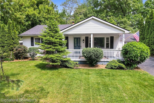 300 Cornell St, Howell, MI 48843 - view of front of house with a front lawn, covered porch, and a shingled roof