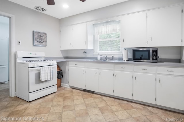 300 Cornell St, Howell, MI 48843 - kitchen featuring white appliances, a sink, ceiling fan, light countertops, and white cabinets