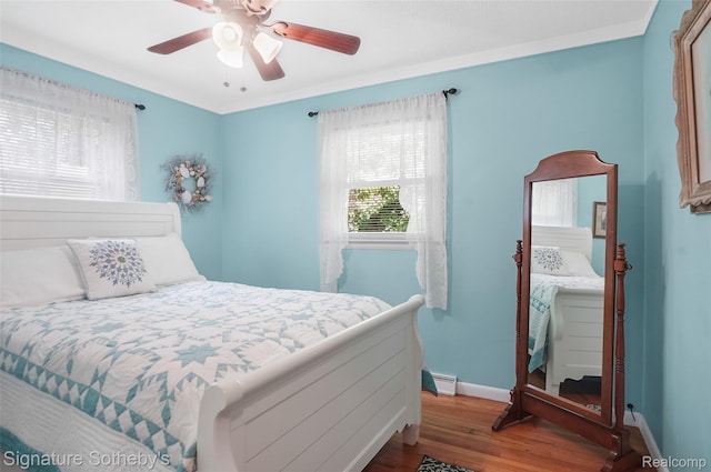 300 Cornell St, Howell, MI 48843 - bedroom featuring wood finished floors, baseboards, baseboard heating, and ceiling fan