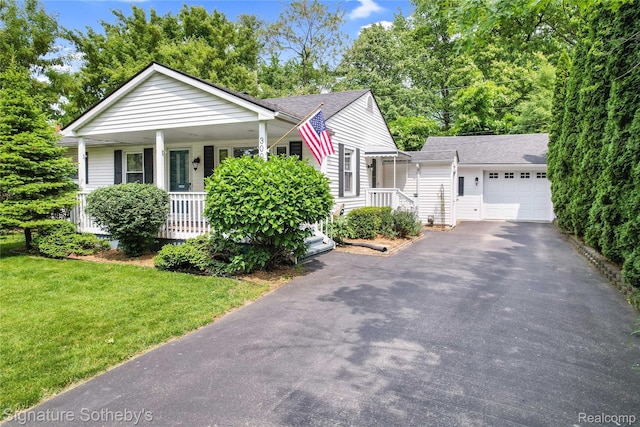 300 Cornell St, Howell, MI 48843 - view of front of home featuring a garage, driveway, a porch, a front lawn, and a shingled roof