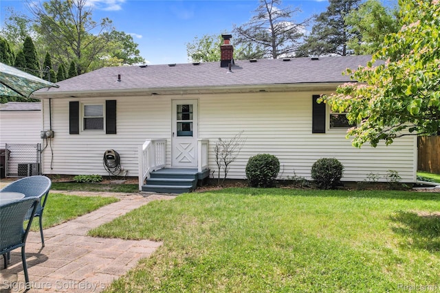 300 Cornell St, Howell, MI 48843 - rear view of property with a chimney, a shingled roof, and cooling unit