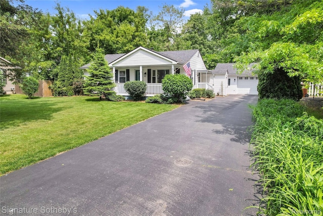 300 Cornell St, Howell, MI 48843 - view of front of home with a porch, driveway, an attached garage, a front yard, and a shingled roof