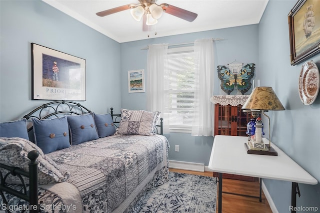 300 Cornell St, Howell, MI 48843 - bedroom featuring wood finished floors, baseboard heating, baseboards, and a ceiling fan