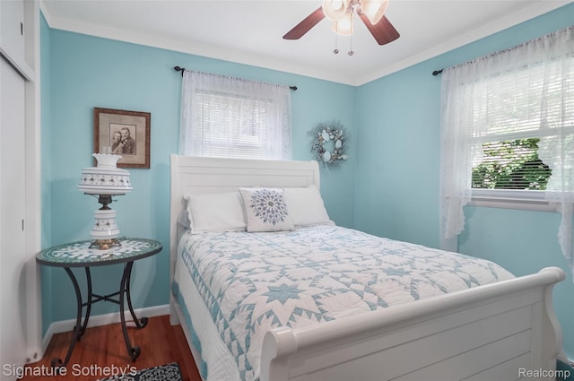 300 Cornell St, Howell, MI 48843 - bedroom featuring multiple windows, wood finished floors, a closet, baseboards, and crown molding
