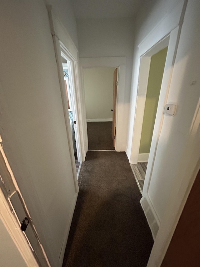 1015 Alvord Ave, Flint, MI 48507 - hallway with dark carpet and baseboards