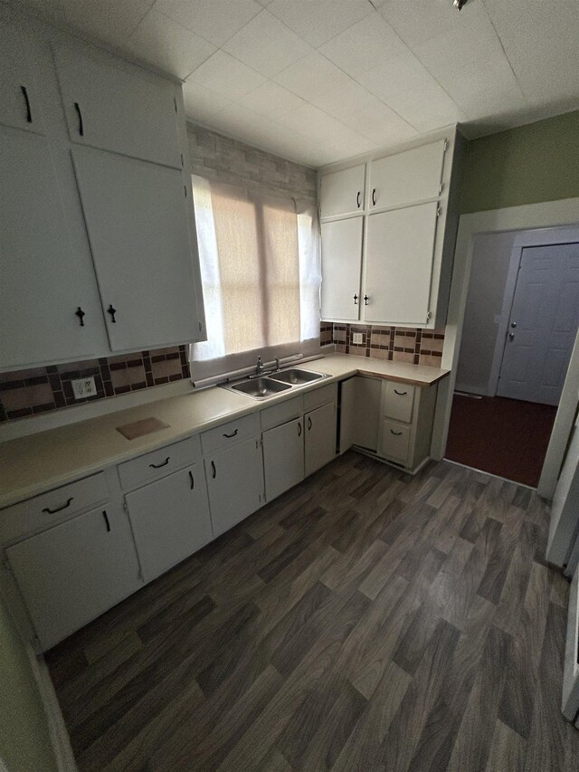1015 Alvord Ave, Flint, MI 48507 - kitchen with light countertops, tasteful backsplash, dark wood finished floors, and a sink