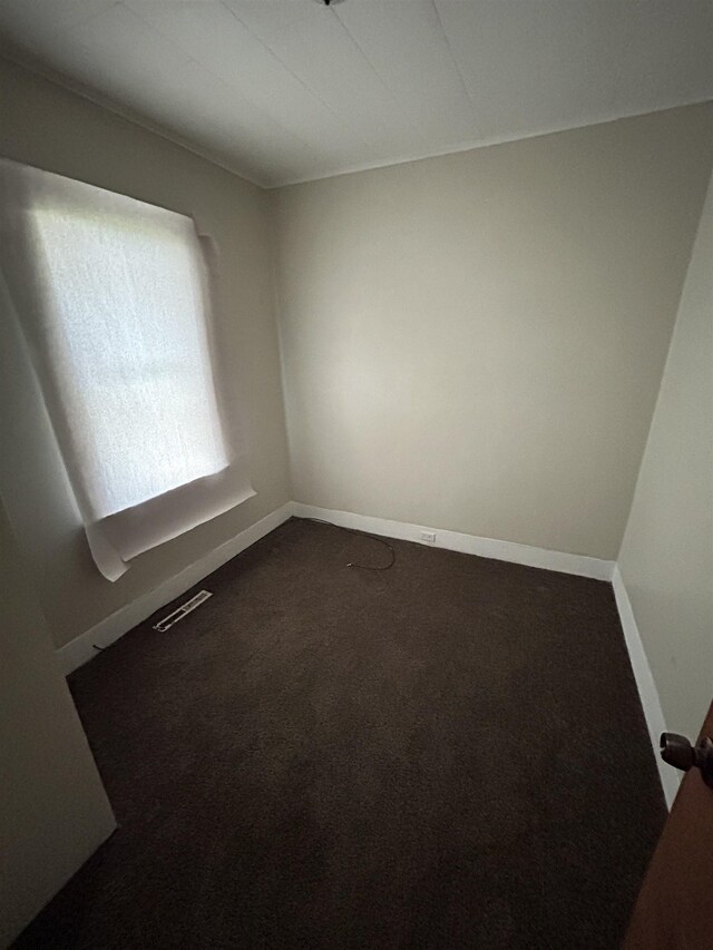 1015 Alvord Ave, Flint, MI 48507 - unfurnished room featuring dark colored carpet and baseboards