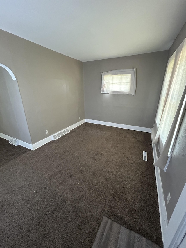 1015 Alvord Ave, Flint, MI 48507 - empty room with baseboards and dark carpet
