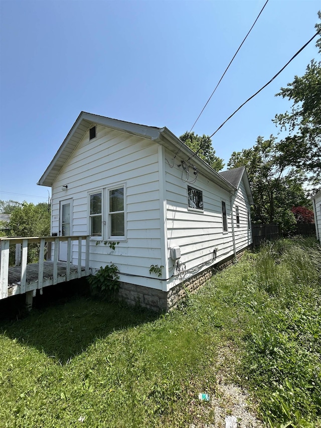 1015 Alvord Ave, Flint, MI 48507 - view of home's exterior with a deck and a lawn
