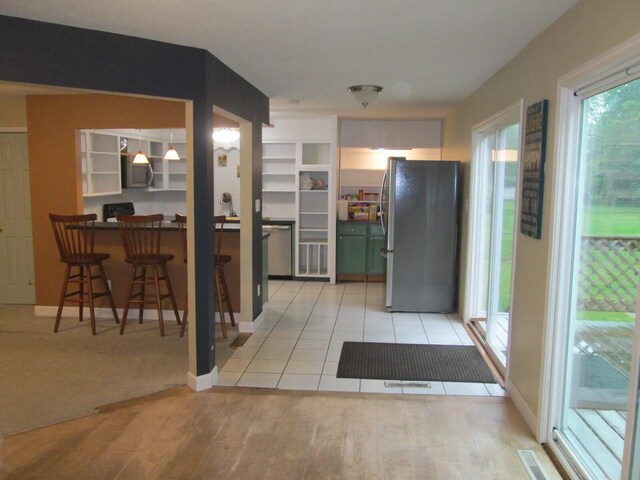 6005 Saint Joseph Ave, Stevensville, MI 49127 - kitchen with appliances with stainless steel finishes, light wood finished floors, baseboards, and dark countertops