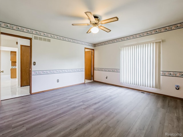 3849 Barg Dr, Warren, MI 48310 - empty room featuring a ceiling fan, wood finished floors, and baseboards