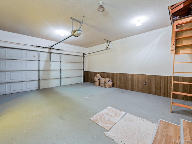 3849 Barg Dr, Warren, MI 48310 - garage with a garage door opener, wainscoting, and wooden walls