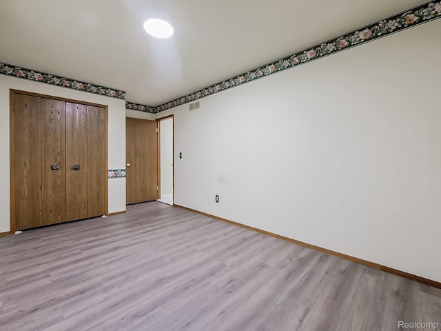 3849 Barg Dr, Warren, MI 48310 - unfurnished bedroom featuring light wood-type flooring, baseboards, and a closet