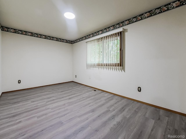 3849 Barg Dr, Warren, MI 48310 - spare room featuring wood finished floors and baseboards