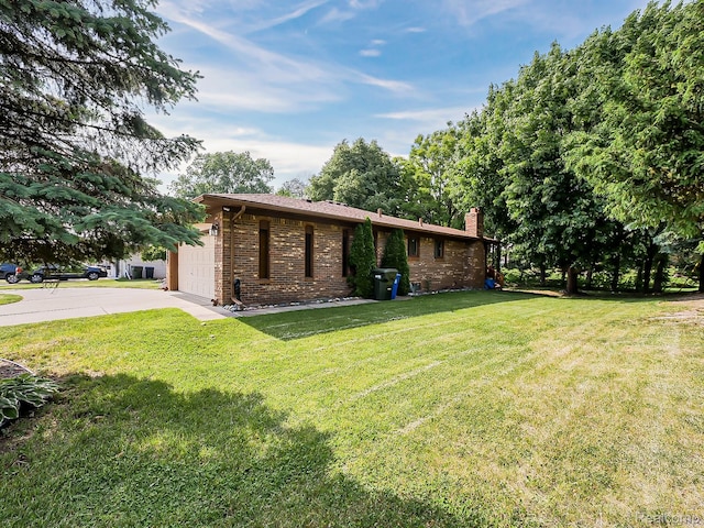 3849 Barg Dr, Warren, MI 48310 - view of front of home featuring a front yard, a chimney, concrete driveway, brick siding, and an attached garage