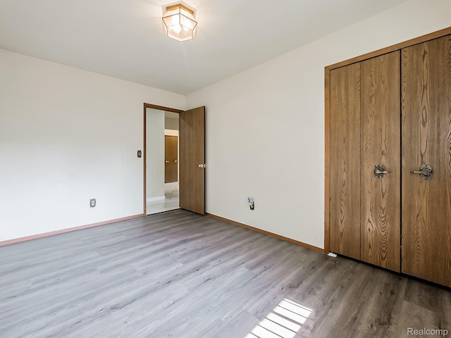 3849 Barg Dr, Warren, MI 48310 - unfurnished bedroom with wood finished floors, baseboards, and a closet