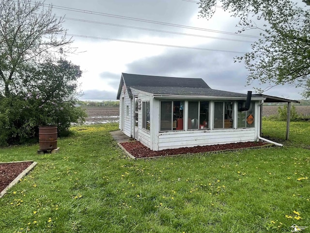 6301 E Albain Rd, Monroe, MI 48161 - view of side of property with a yard, a sunroom, and a shingled roof