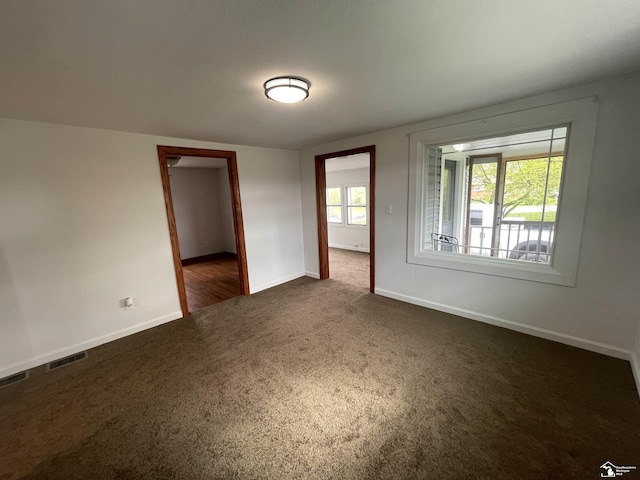 6301 E Albain Rd, Monroe, MI 48161 - empty room featuring dark carpet and baseboards
