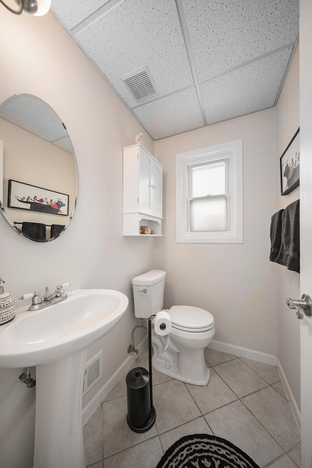 489 Old Creek Ct, Saline, MI 48176 - bathroom featuring a paneled ceiling, tile patterned flooring, toilet, and baseboards