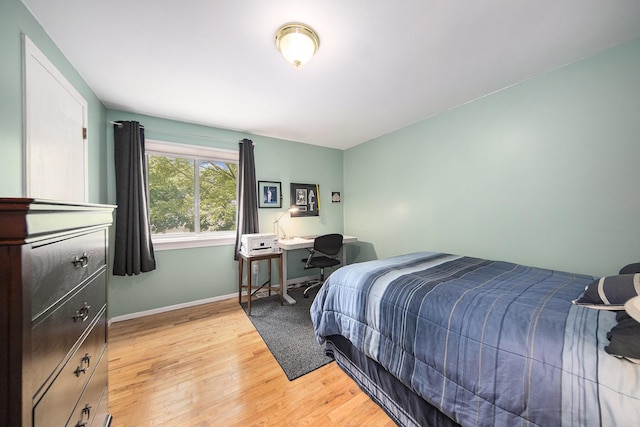489 Old Creek Ct, Saline, MI 48176 - bedroom with light wood-type flooring, baseboards, and a desk
