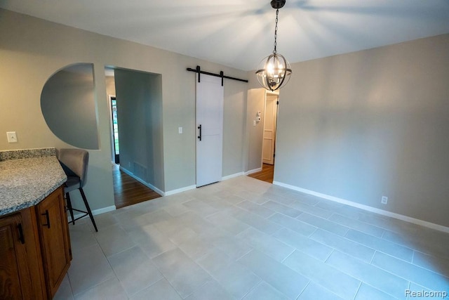 24449 Laurel St, Flat Rock, MI 48134 - unfurnished dining area with a barn door, baseboards, light tile patterned flooring, and a chandelier