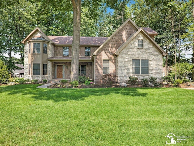 9241 Legacy Ct, Temperance, MI 48182 - view of front of house with stone siding, a front yard, and roof with shingles
