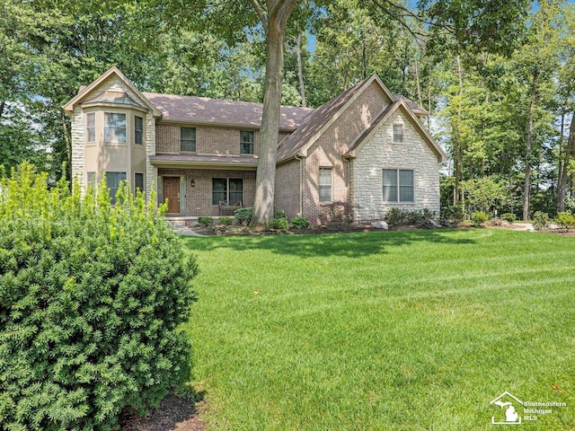 9241 Legacy Ct, Temperance, MI 48182 - view of front facade with a front yard, stone siding, and brick siding