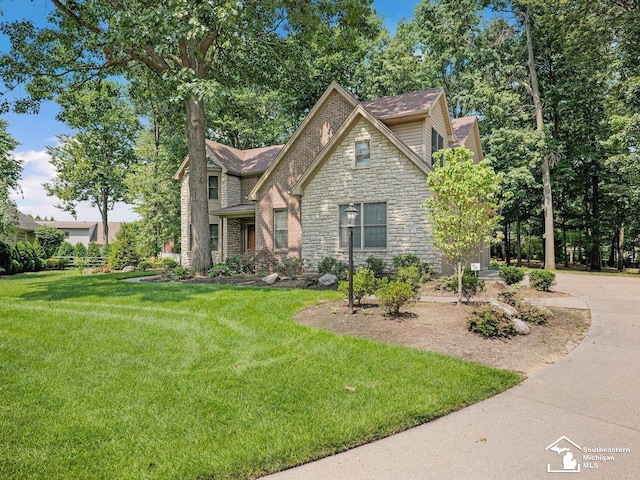 9241 Legacy Ct, Temperance, MI 48182 - view of front facade featuring stone siding and a front yard