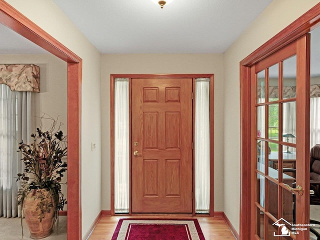 9241 Legacy Ct, Temperance, MI 48182 - foyer entrance featuring light wood finished floors and baseboards