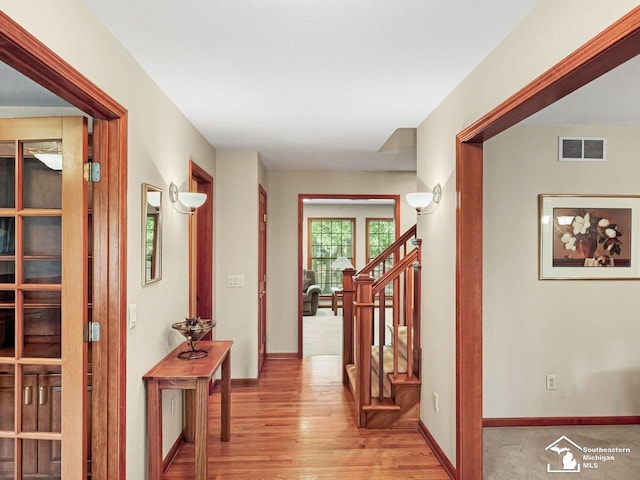 9241 Legacy Ct, Temperance, MI 48182 - hallway featuring wood finished floors, baseboards, and stairway