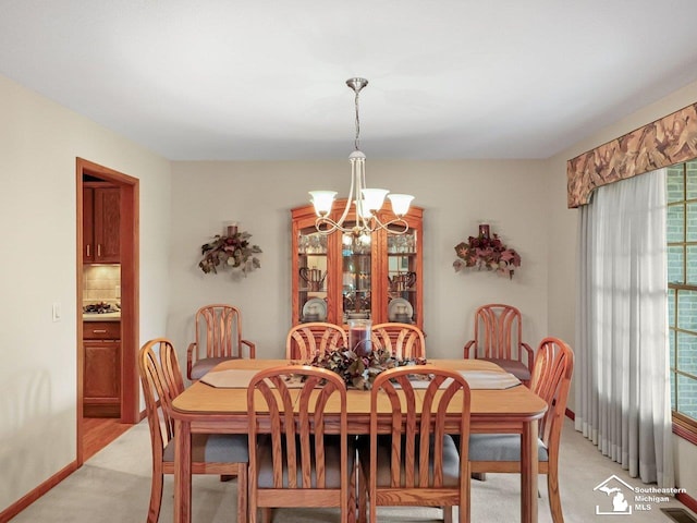 9241 Legacy Ct, Temperance, MI 48182 - dining space featuring a chandelier and light carpet