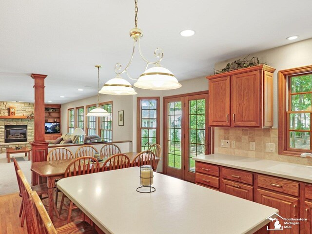 9241 Legacy Ct, Temperance, MI 48182 - kitchen with a sink, a kitchen island, light countertops, wood finished floors, and recessed lighting